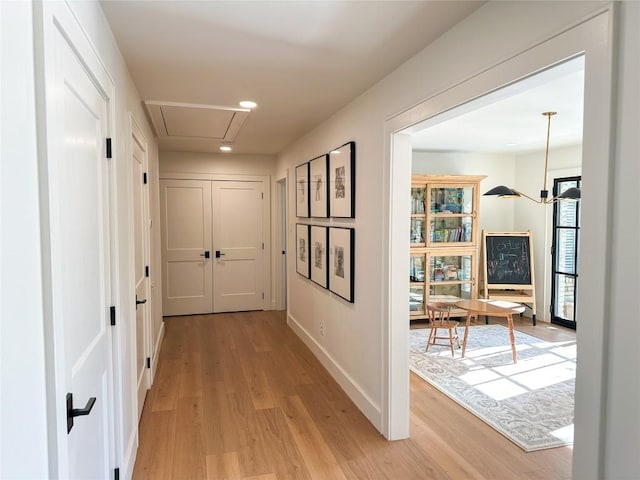 hallway with light hardwood / wood-style flooring