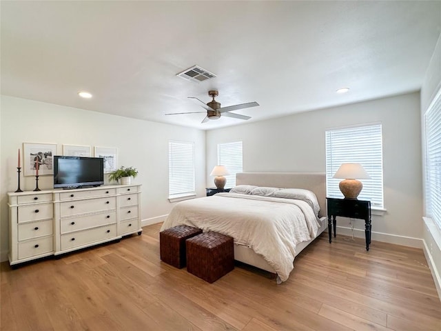 bedroom with multiple windows, ceiling fan, and light wood-type flooring