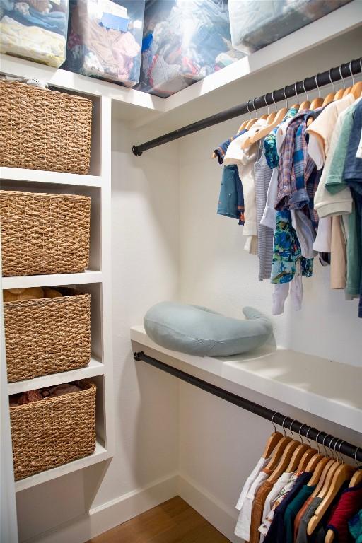 spacious closet with hardwood / wood-style floors