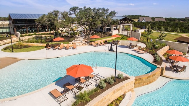 view of swimming pool with a patio and a gazebo