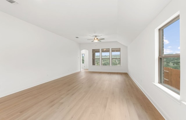 6420 Apache Plum Ln, Spicewood, TX 78669 - unfurnished living room featuring light wood finished floors, ceiling fan, and arched walkways