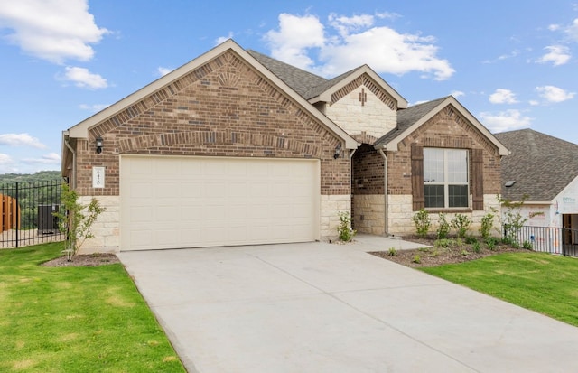 6420 Apache Plum Ln, Spicewood, TX 78669 - view of front of property with stone siding, an attached garage, concrete driveway, and brick siding