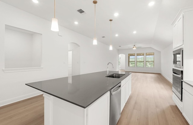 6420 Apache Plum Ln, Spicewood, TX 78669 - kitchen featuring stainless steel appliances, arched walkways, light wood finished floors, a ceiling fan, and recessed lighting