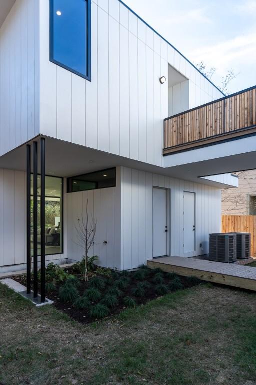 rear view of house featuring central air condition unit