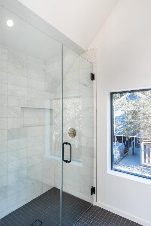 bathroom featuring lofted ceiling and an enclosed shower