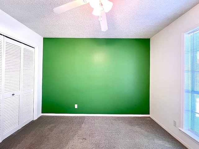 unfurnished bedroom with carpet floors, a textured ceiling, and a closet