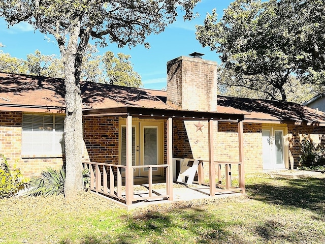 back of property featuring a yard and a patio