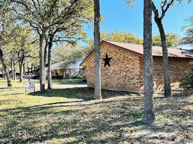 view of side of home featuring a lawn