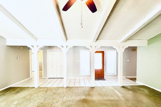 interior space with ceiling fan, light colored carpet, and beam ceiling