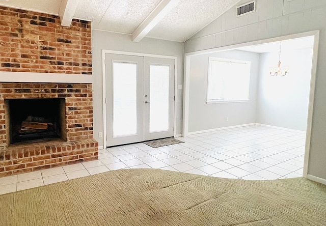 entryway featuring lofted ceiling with beams, light tile patterned floors, a textured ceiling, an inviting chandelier, and french doors