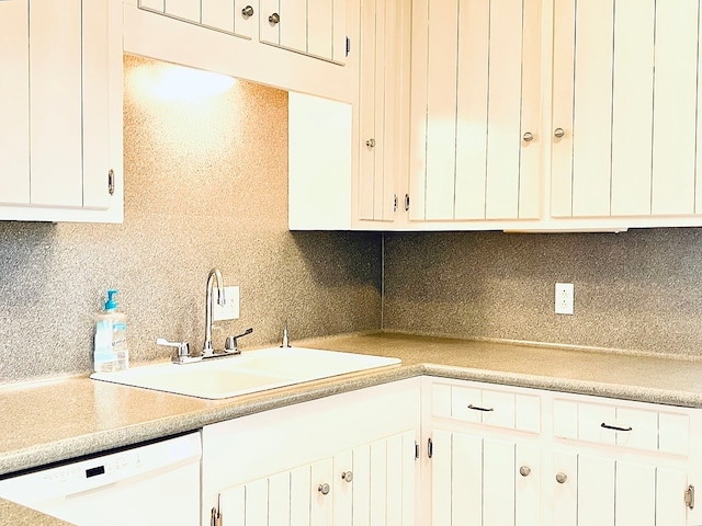 kitchen featuring white cabinetry, sink, backsplash, and dishwasher