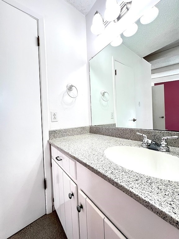 bathroom with vanity and a textured ceiling