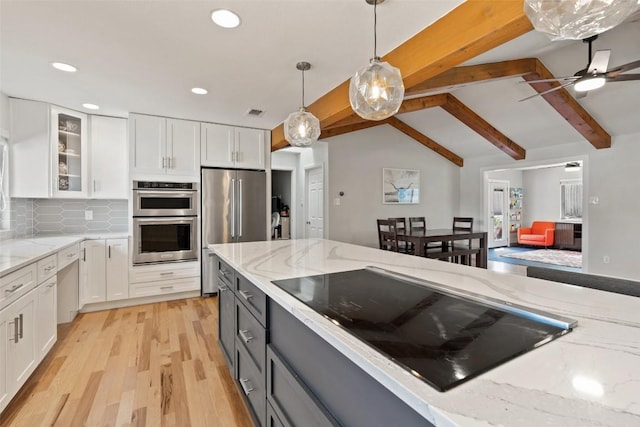 kitchen featuring appliances with stainless steel finishes, lofted ceiling with beams, gray cabinetry, white cabinets, and hanging light fixtures