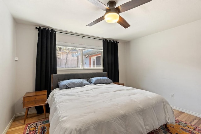 bedroom with hardwood / wood-style flooring and ceiling fan