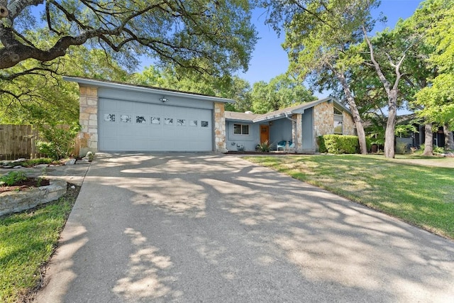 ranch-style house featuring a garage and a front yard