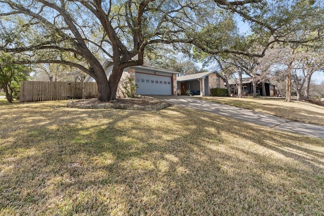 view of front of property featuring a garage and a front lawn