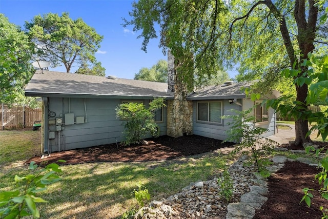 rear view of house with a lawn