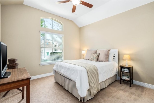 bedroom with ceiling fan, vaulted ceiling, and light carpet