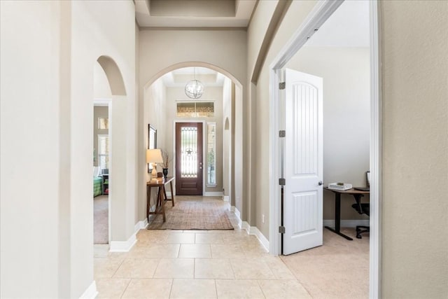 tiled foyer featuring a high ceiling