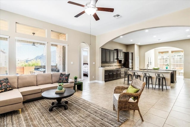 tiled living room featuring sink and ceiling fan