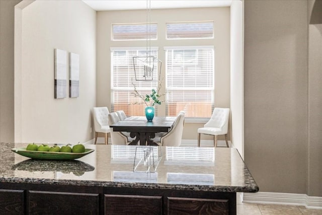 dining room featuring light tile patterned flooring and a healthy amount of sunlight