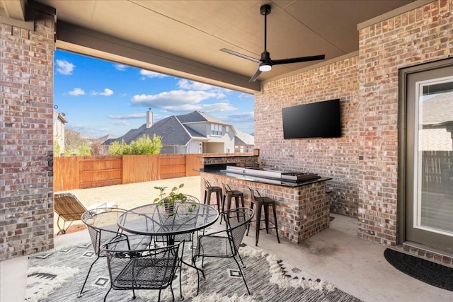 view of patio with ceiling fan and exterior bar