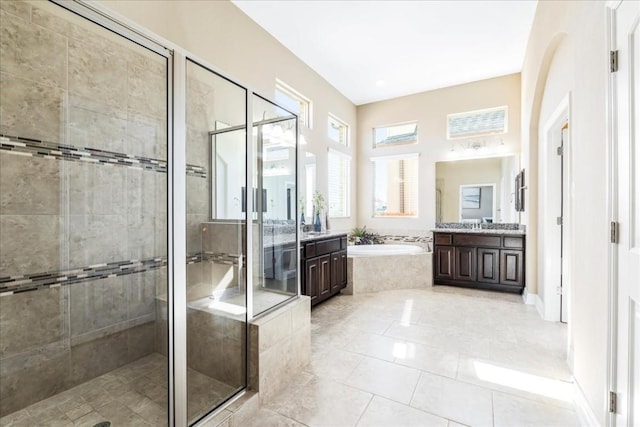 bathroom featuring vanity, tile patterned floors, and shower with separate bathtub