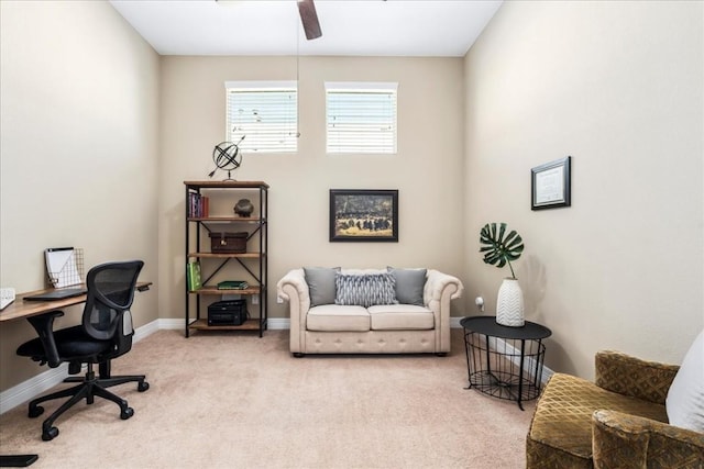 carpeted home office featuring ceiling fan