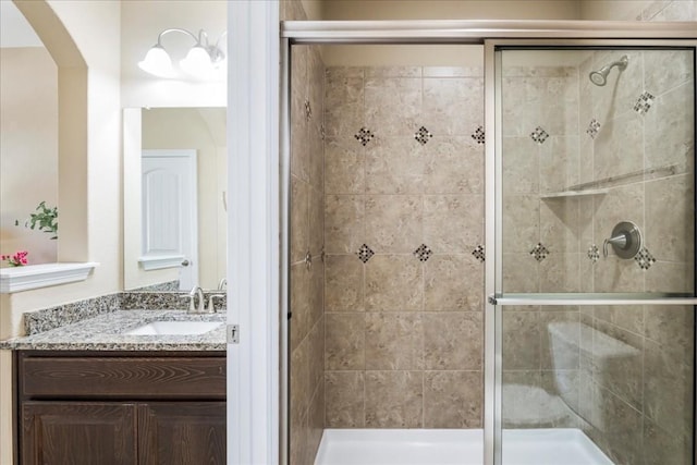 bathroom with vanity and a shower with shower door