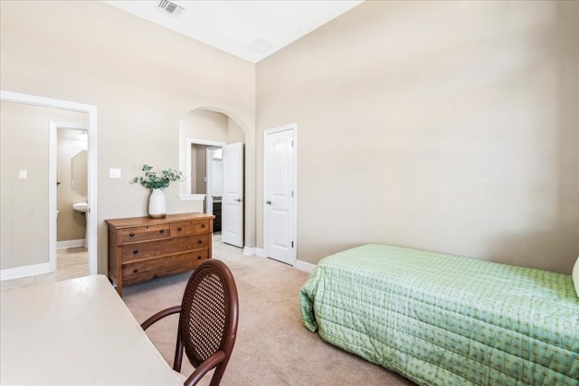 carpeted bedroom with connected bathroom