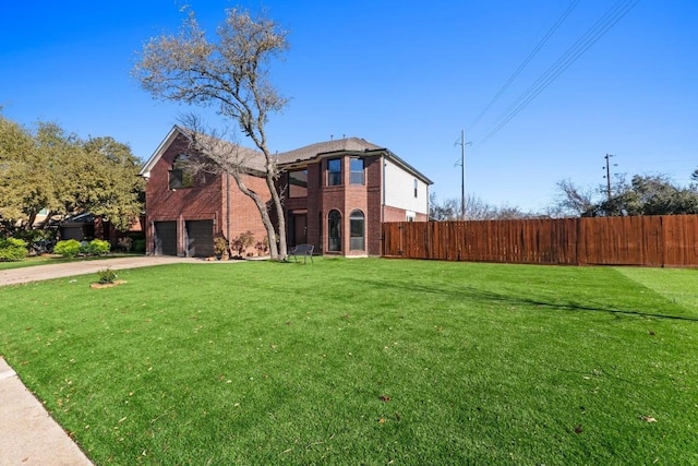 view of front of home with a garage and a front yard