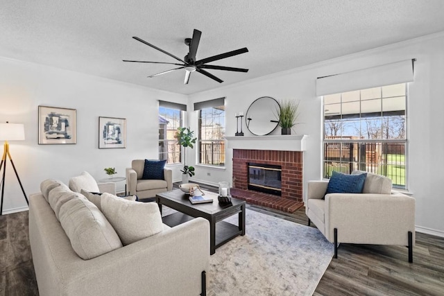 living room with plenty of natural light, dark wood-type flooring, a fireplace, and a textured ceiling