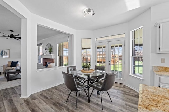 dining room with dark wood-type flooring, french doors, and ceiling fan