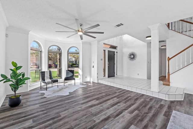 unfurnished living room with hardwood / wood-style floors, crown molding, a textured ceiling, and ceiling fan