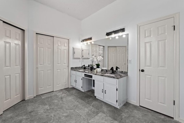 bathroom with vanity and lofted ceiling