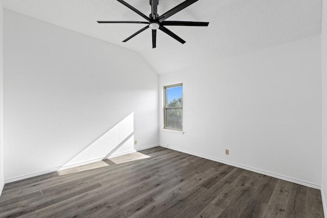 spare room with dark hardwood / wood-style flooring, lofted ceiling, and ceiling fan