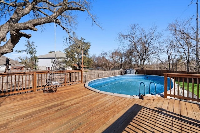 view of swimming pool with a deck