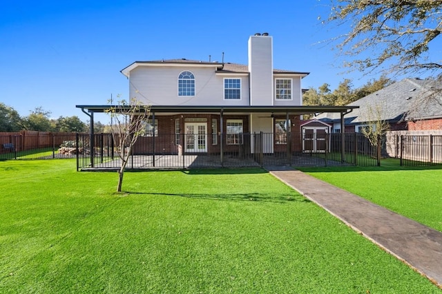 back of house featuring a lawn