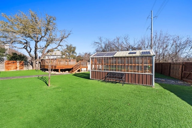 view of yard with a wooden deck and an outbuilding