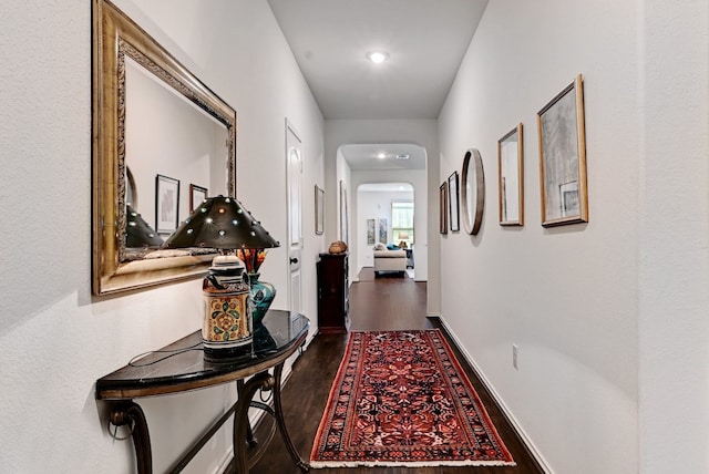 7617 Ballydawn Dr, Austin, TX 78744 - hall featuring dark wood-style flooring, arched walkways, and recessed lighting