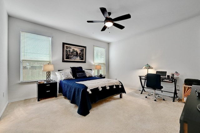 bedroom featuring light carpet and ceiling fan