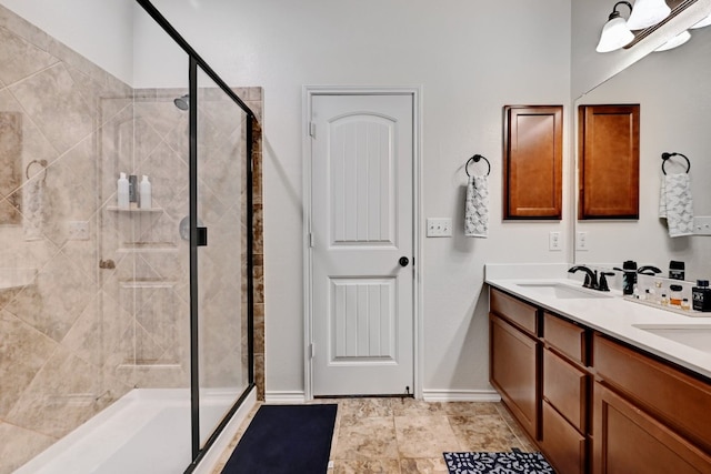 7617 Ballydawn Dr, Austin, TX 78744 - bathroom featuring a stall shower, double vanity, and baseboards