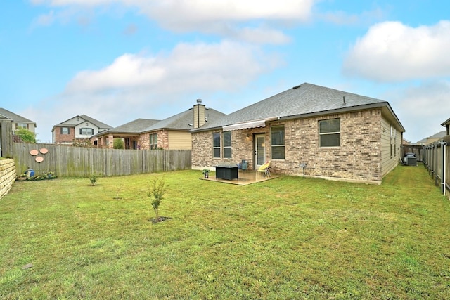 7617 Ballydawn Dr, Austin, TX 78744 - back of house featuring a patio, brick siding, and roof with shingles