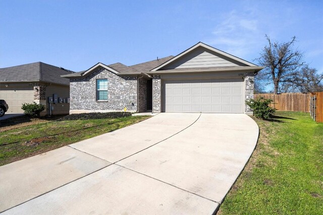 ranch-style house with a front yard, fence, driveway, and an attached garage