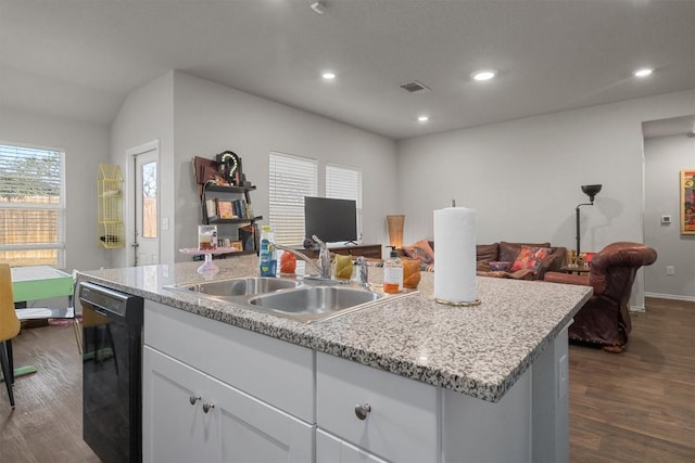 kitchen with dark hardwood / wood-style floors, black dishwasher, sink, white cabinets, and a center island with sink