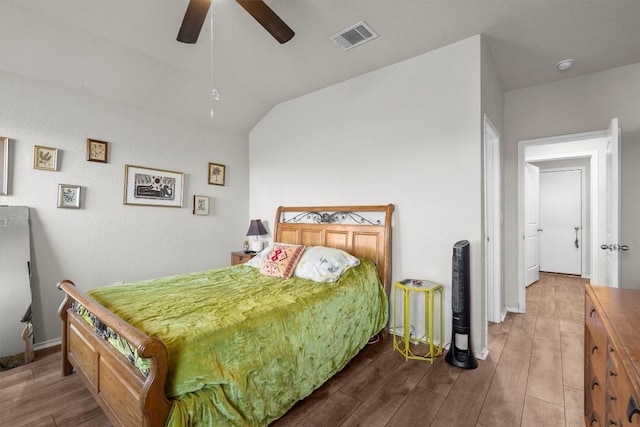 bedroom with hardwood / wood-style flooring, lofted ceiling, and ceiling fan