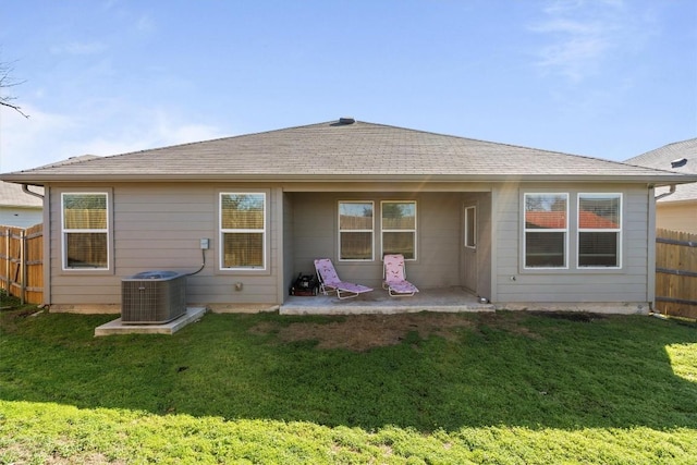 rear view of property with a patio area, a lawn, and central air condition unit