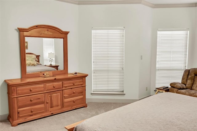 bedroom featuring crown molding and light carpet