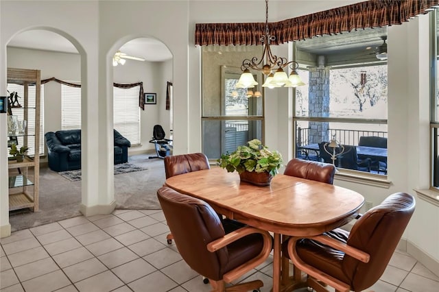 tiled dining space with an inviting chandelier