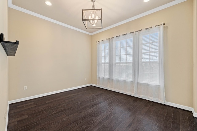 empty room with ornamental molding, a notable chandelier, and dark hardwood / wood-style flooring